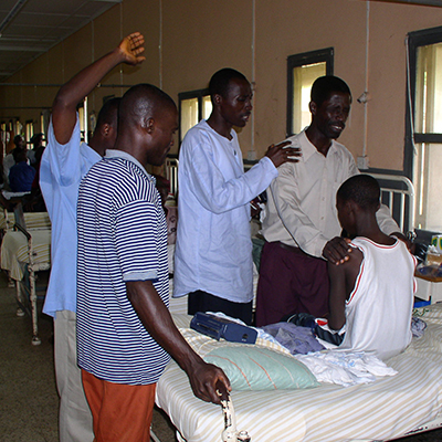 Students pray for a boy in the hospital